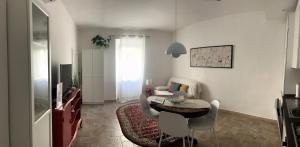 a living room with a table and a dining room at Suite in Borgo in Greve in Chianti