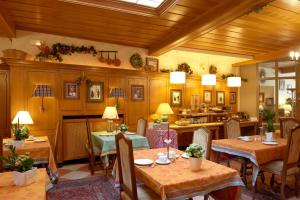 a restaurant with tables and chairs in a room at Chez Jean in Saverne