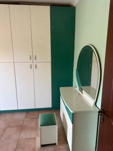 a bathroom with a white sink and a mirror at Villa canty in Nea Potidaea +22 photos