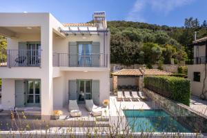 a villa with a swimming pool and a house at YaChara Villa in Kissamos