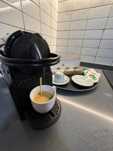 a coffee maker is making a cup of coffee at Casa Dolce Casa in Valencia