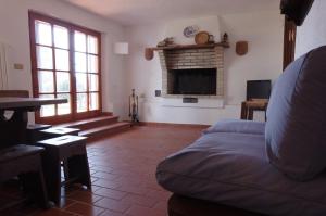 a living room with a couch and a fireplace at La Casa di Betta in Marcelli