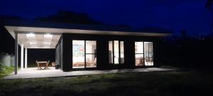 a small house with a porch at night at Audreys Place in Matei