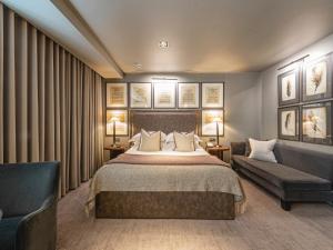 a hotel room with a bed and a couch at Dakota Leeds in Leeds