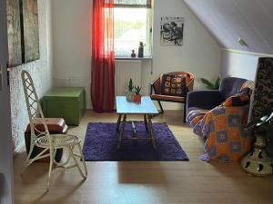 a living room with a table and a couch at B&B Het Oude Dorpscafé in Zorgvlied