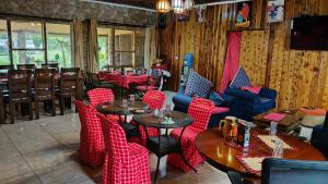a restaurant with red checkered chairs and tables at Mara Silalei in Narok