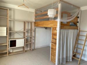 a bedroom with bunk beds and a ladder at Großzügige Ferienwohnung nahe Berlin in Nauen +15 photos
