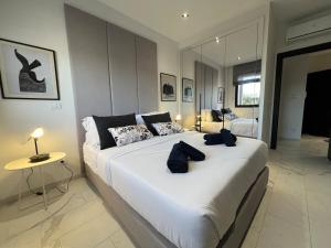 a bedroom with a large white bed in a room at Only You in Sidi Daoud