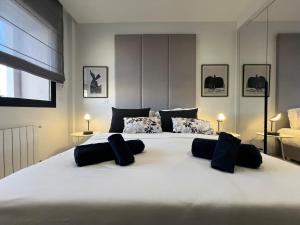 a large white bed with two pillows on it at Only You in Sidi Daoud