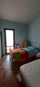 a bedroom with two beds and a window at Villa Manuela in Silvi Marina