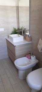 a bathroom with a white sink and a toilet at Villa Manuela in Silvi Marina +17 photos