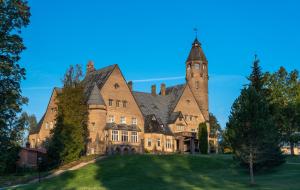 an old castle with a tower on top of a lawn at Castle Spa Wagenküll in Taagepera