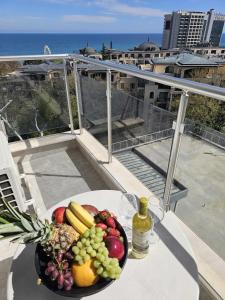 a bowl of fruit on a table on a balcony at Europroperties Yalta Apartments in Golden Sands