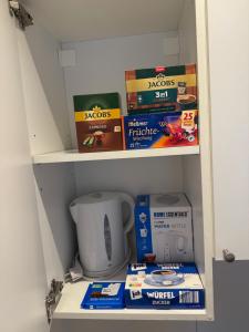 a book shelf with books and boxes on it at Milis Apartments in Radolfzell am Bodensee