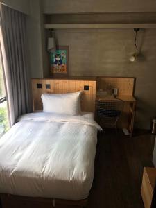 Postel nebo postele na pokoji v ubytování Just Inn Xin Yi 正旅館 信義