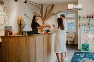 a bride and groom standing at the bar at their wedding reception at Chateau d'Urspelt in Urspelt +144 photos