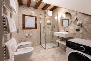 a bathroom with a toilet sink and a shower at Ca' San Geremia in Venice