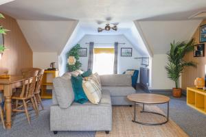 a living room with a couch and a table at Ashley Suite - Cozy 1BR Maisonette with Parking & WIFI in Barry
