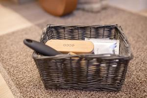 a basket with a knife and other items on a rug at Lukiškės Central Apartment - Self Check-in and Parking Option in Vilnius