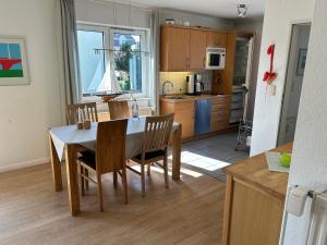 a kitchen and dining room with a table and chairs at Haus Potosi, Travemünde in Lübeck