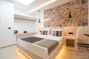 A bed or beds in a room at Illusion Suites