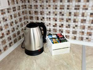 a coffee pot sitting next to a box of books at Apartment Leona in Inđija