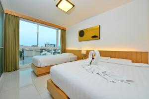 Postel nebo postele na pokoji v ubytování Modern Thai Suites