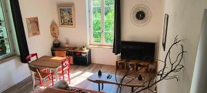 a living room with a table and a fireplace at Maison du Pont Canal in Agen