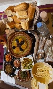 a tray of food with a plate of food with bread at APPARTEMENT TAMAZIGHT Ensoleillé in Inezgane