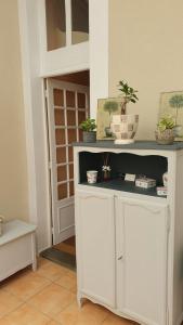 a room with a white shelf with potted plants on it at La maison d`hôtes de Constance in Le Mans +40 photos