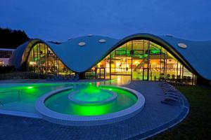 a large building with a pool in front of it at Haus am Jungbrunnen Apartment 1 in Bad Orb