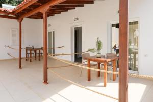 a patio with a rope and a table and chairs at Colette's Comfort in Himare