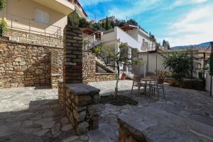 a patio with a table and a building at Colette's Comfort in Himare