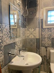 a bathroom with a sink and a mirror at Baraa house in Cairo +47 photos