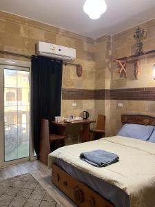 a bedroom with a bed and a table with a table at Baraa house in Cairo