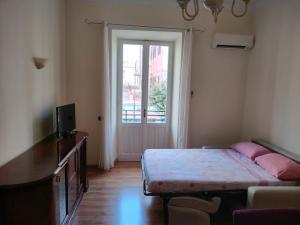 a bedroom with a bed and a door with a window at La casa di Norma- Anzio Centro 4 posti letto in Anzio
