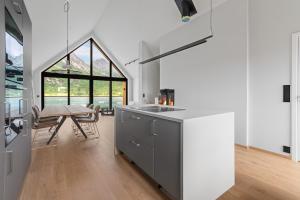 a kitchen with a table and a dining room at New sea house in Steigen in Steigen