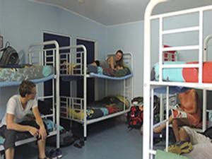 a group of people in a room with bunk beds at Reef Lodge Backpackers in Townsville