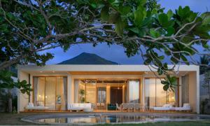 a house with a mountain in the background at Adika Beach Villas in Chaloklum