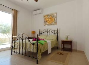 a bedroom with a bed in a room with a window at Casa Violetta in Alicante +10 photos