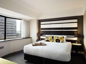 Postel nebo postele na pokoji v ubytování Mövenpick Hotel Auckland
