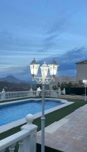 a street light next to a swimming pool at Casa Violetta in Alicante