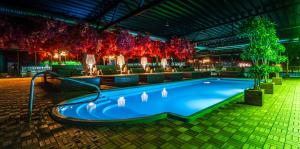 a large swimming pool in a building with lights at Castle Spa Wagenküll in Taagepera