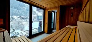 a room with a bench in front of a large window at NordOst fineliving in Ischgl