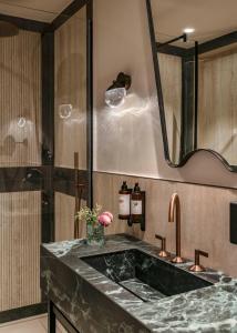 a bathroom with a marble sink and a mirror at Vincci Centrum in Madrid