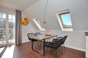 a dining room with a table and chairs at Villa Seepferdchen Wohnung 09 in Kühlungsborn
