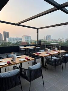 a restaurant with tables and chairs and a view of the city at Grand La Vogue Hotel and Casino in Sihanoukville