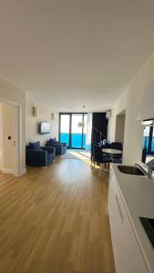 a kitchen and living room with a couch and a table at ORBI CITY Batumi 2 bedrooms Panorama Sea & Mountain View in Batumi +11 photos