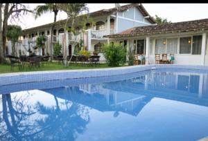 a swimming pool in front of a house at Sonhos ML ApartHotel in Búzios +10 photos
