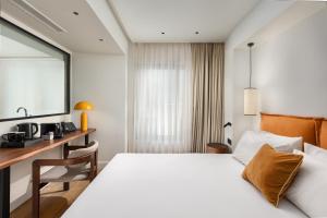a hotel room with a bed and a desk at The Residence Aiolou Hotel & Spa in Athens